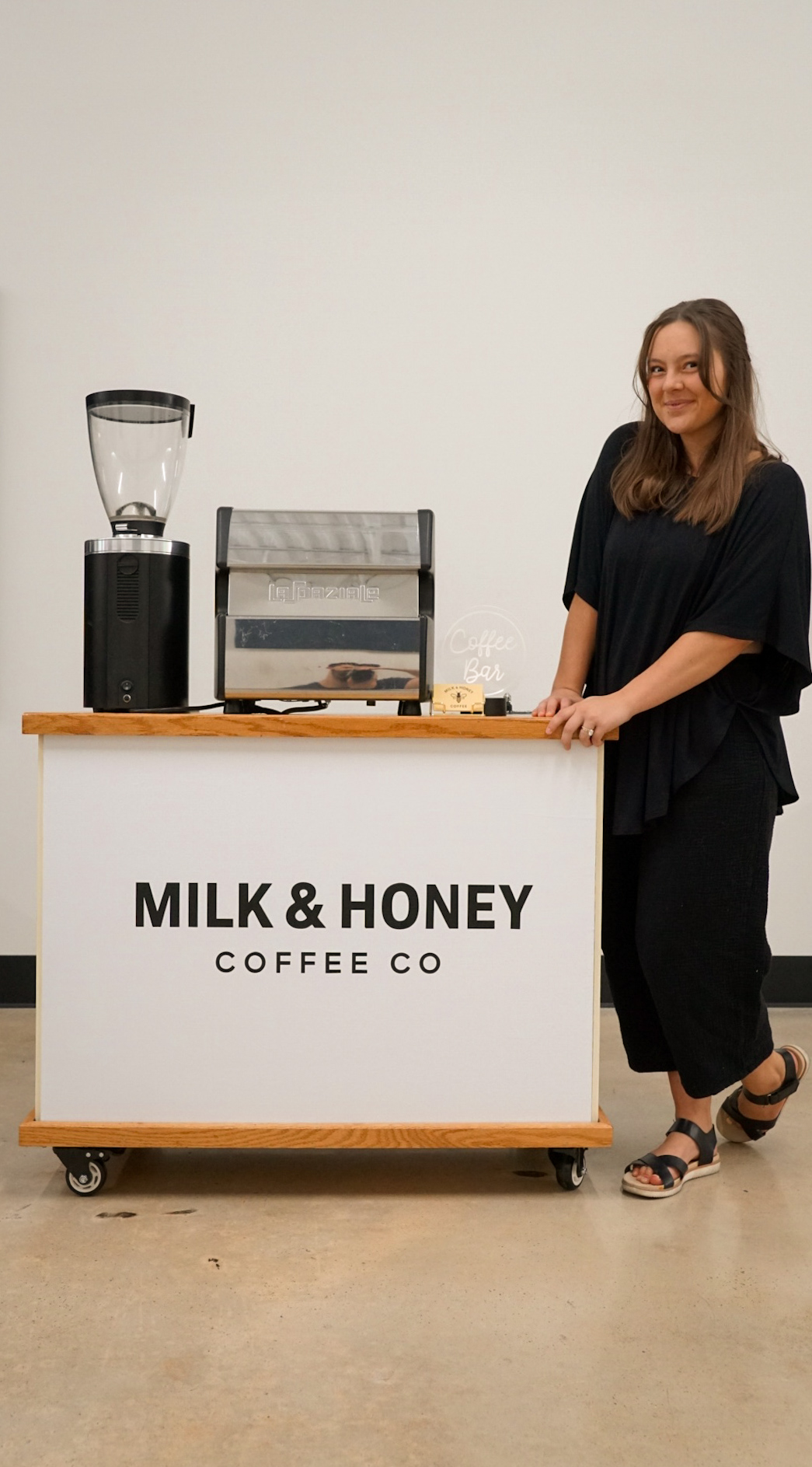 Professional barista with Milk & Honey mobile coffee cart for event catering