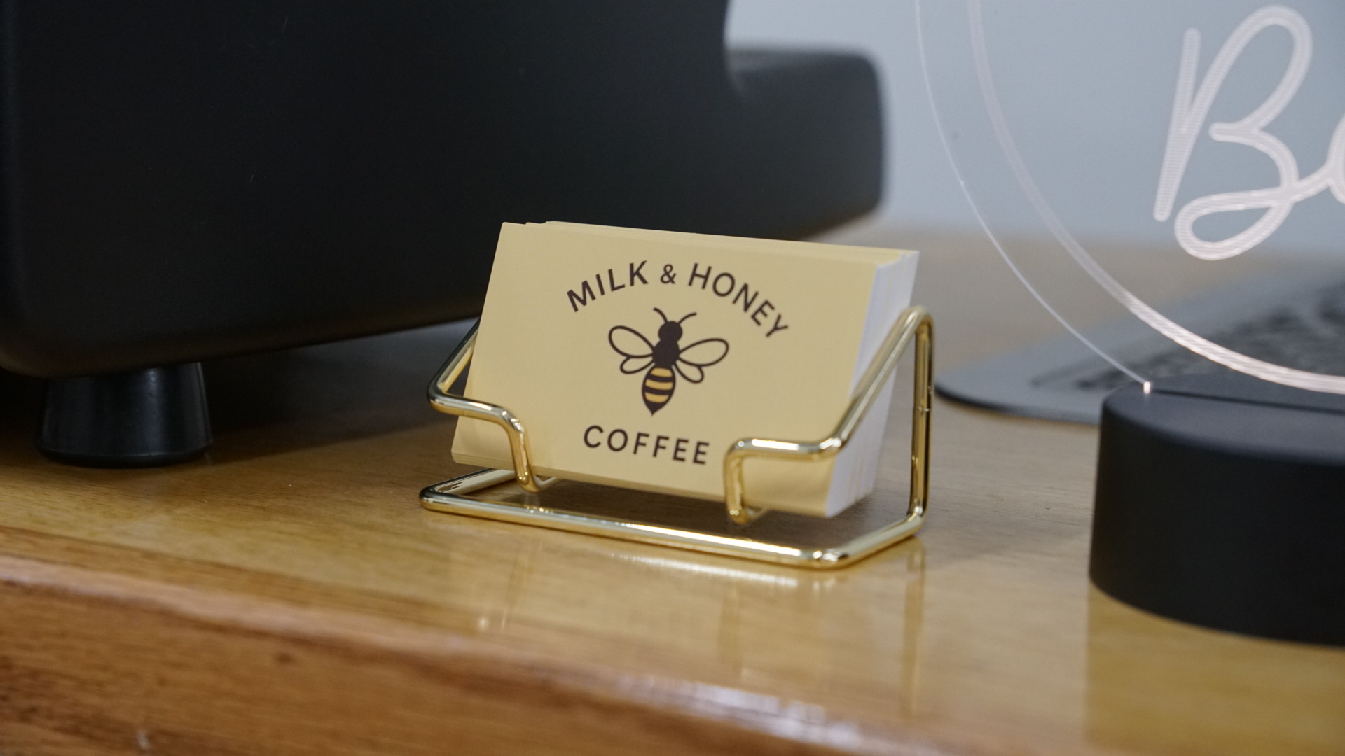 Milk & Honey Coffee business card with bee logo on coffee cart