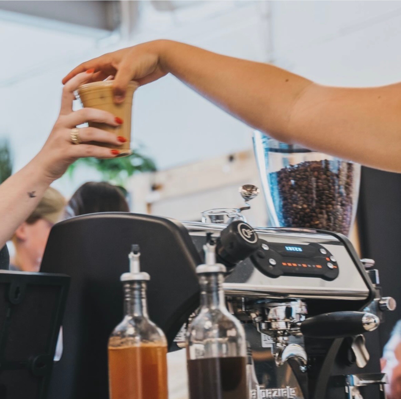Barista preparing specialty coffee drinks at mobile espresso bar event